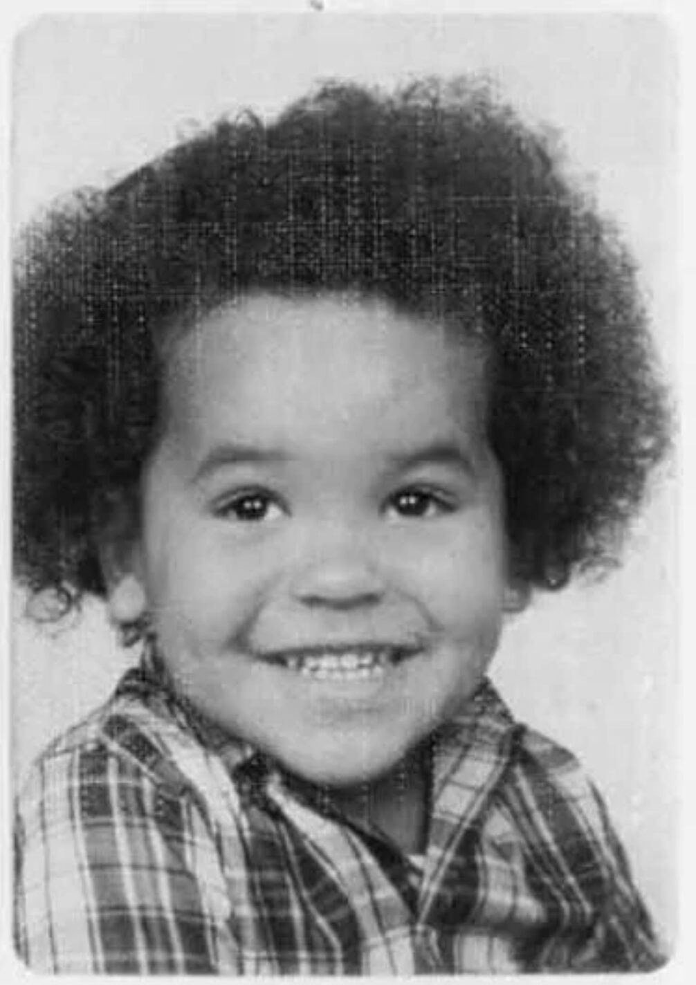 Black-and-white school portrait of Nanon as a young boy.