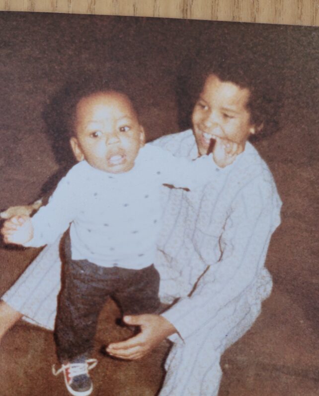 An old family photo of two young children playing.