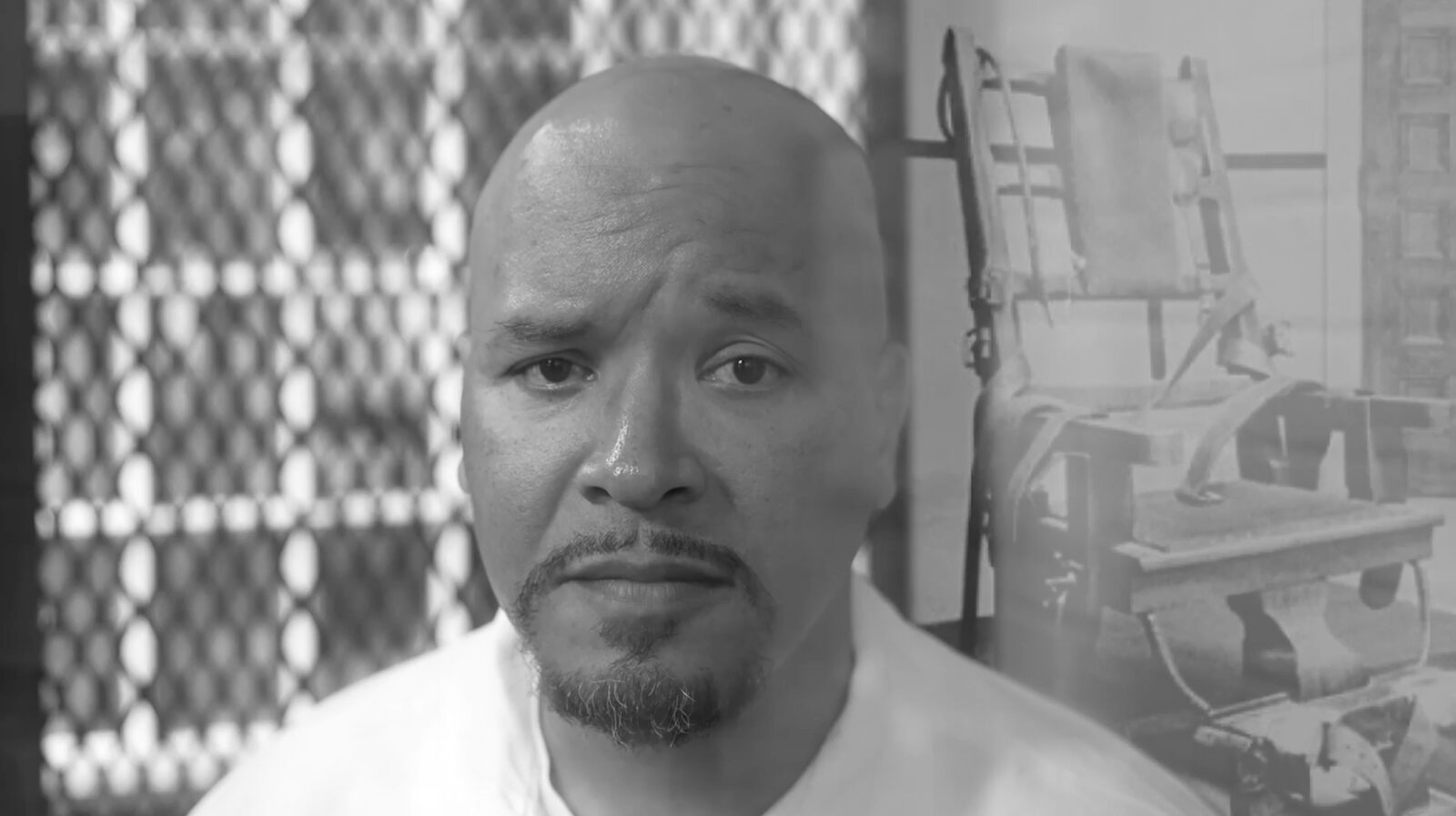 Black-and-white portrait of Nanon in front of a chain-link fence and a photograph of an electric chair.