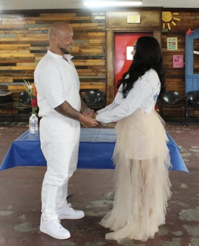 Nanon and Tera holding hands on their wedding day.